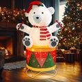 Pre-lit glittered bear sitting on a drum by a front door