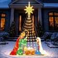 Colorful lighted nativity scene glowing on a front lawn at night