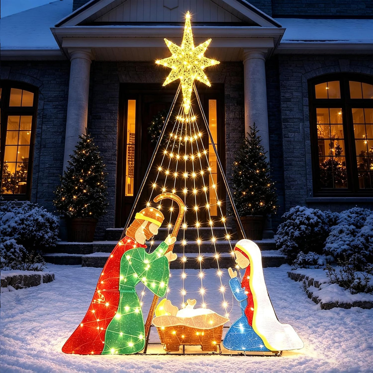 Colorful lighted nativity scene glowing on a front lawn at night